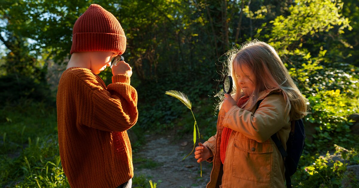deux jeunes enfants dans la nature avec des loupes